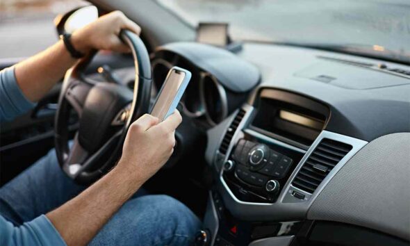 Guida con lo smartphone in mano
