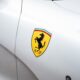 Logo Ferrari applicato su una carrozzeria bianca.